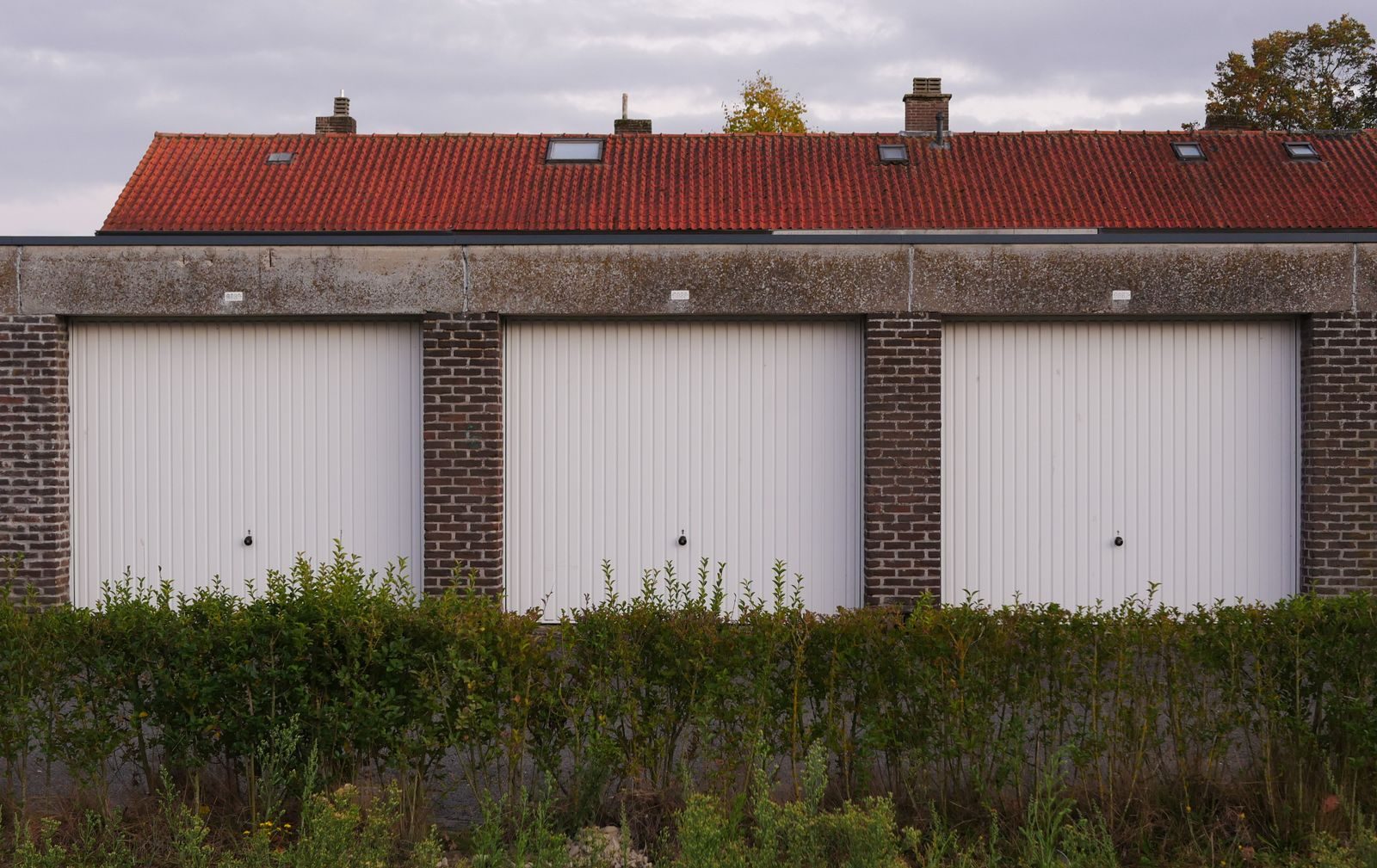 Garage block with an ageing tiled roof